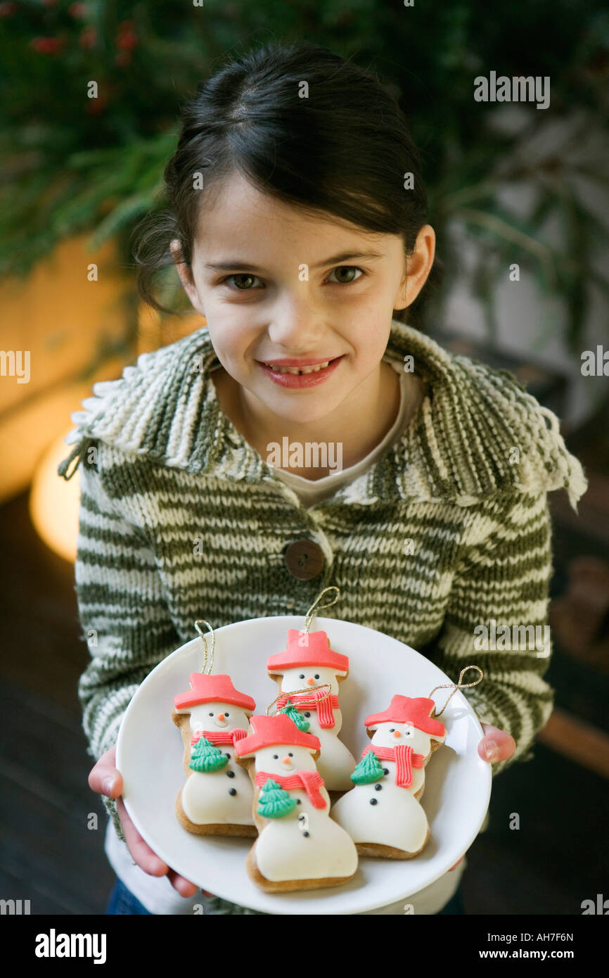 High angle view of a girl holding a plate of cookies Stock Photo