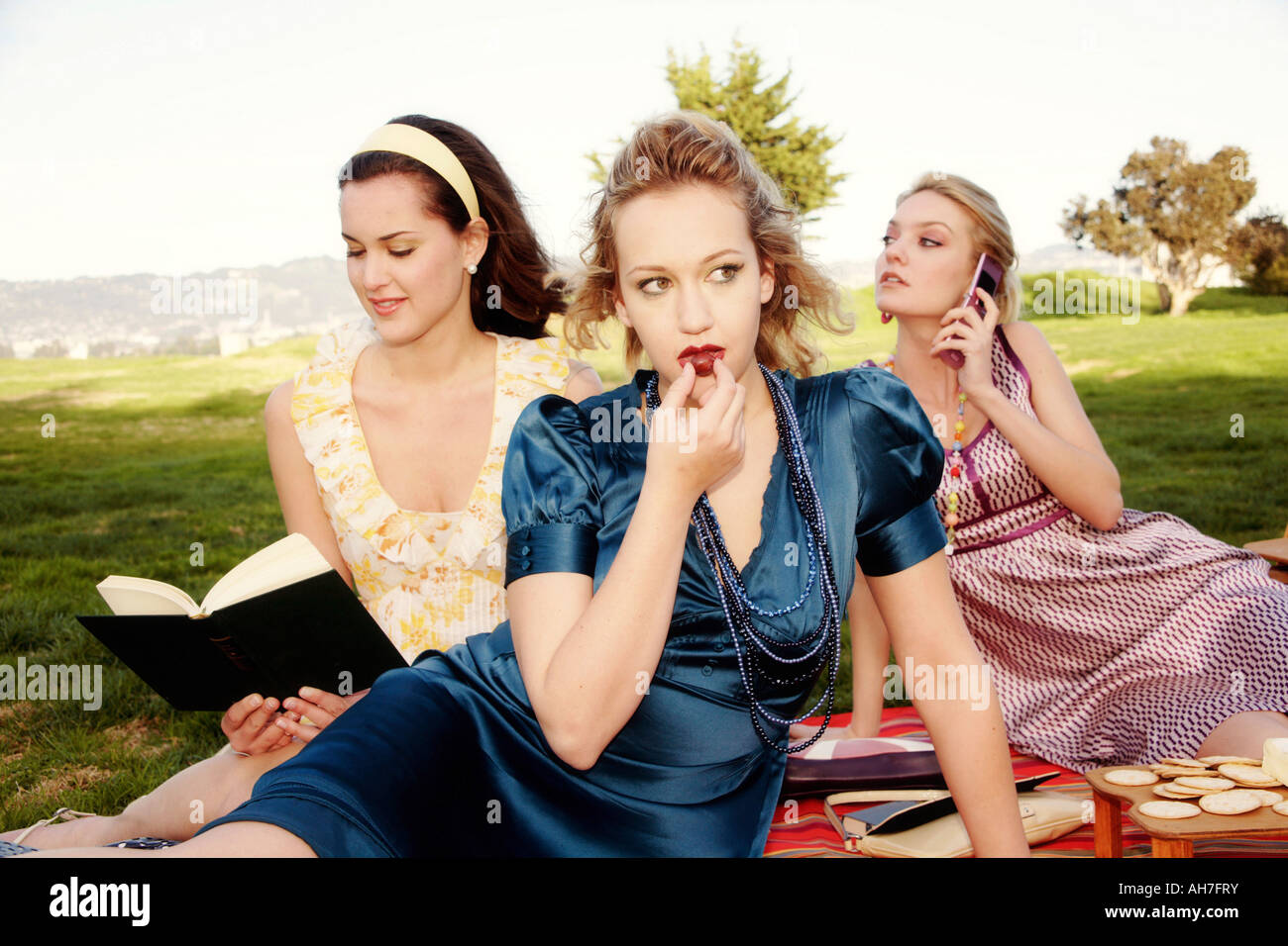 Three young women at a picnic Stock Photo