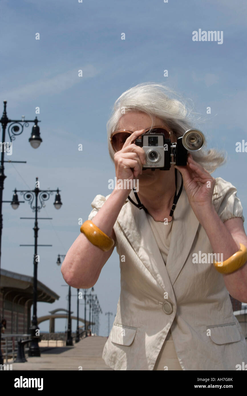 Senior woman taking a photograph Stock Photo