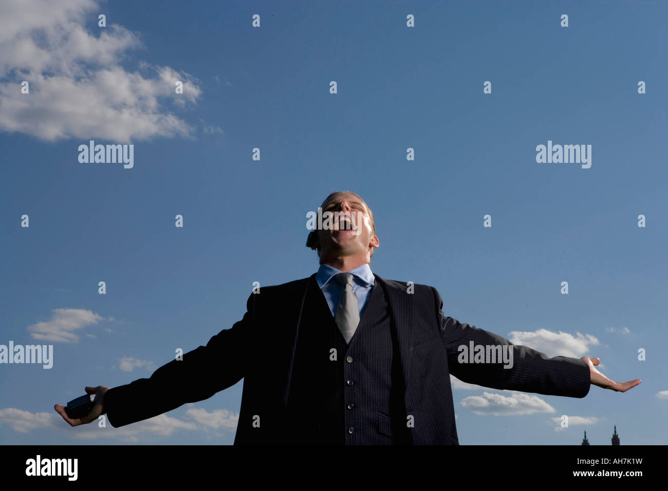 Low angle view of a businessman shouting with his arms outstretched Stock Photo