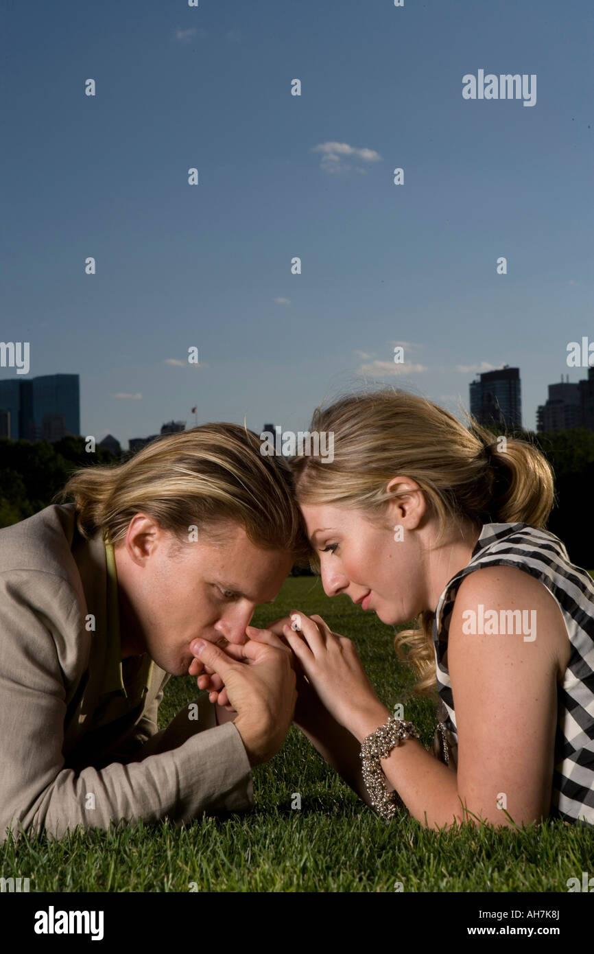 Young couple lying in a park and being romantic, Central Park, Manhattan, New York City, New York, USA Stock Photo