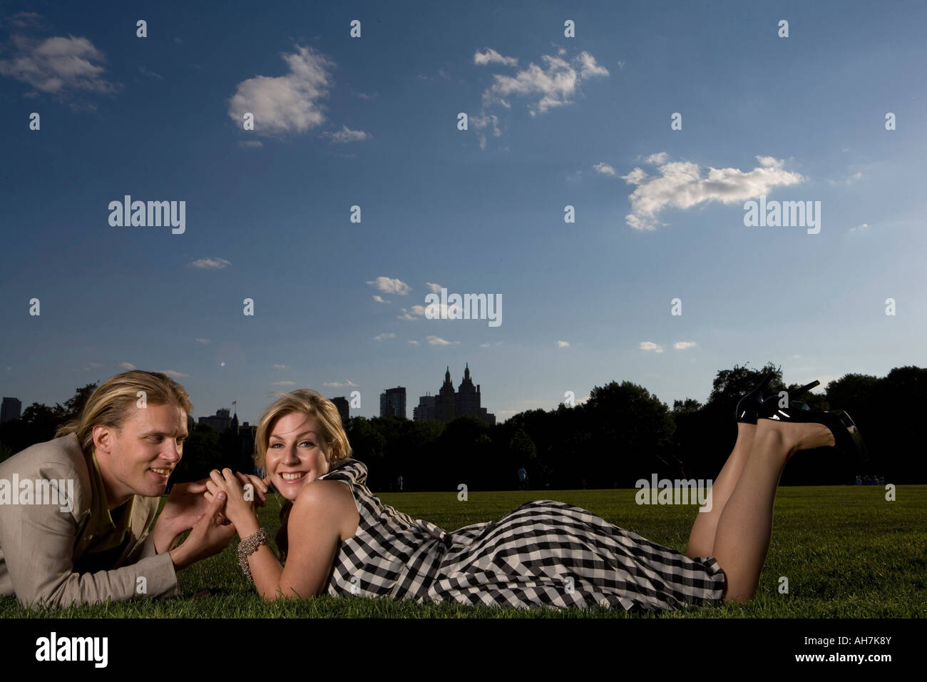 Young couple lying in a park and being romantic, Central Park, Manhattan, New York City, New York, USA Stock Photo