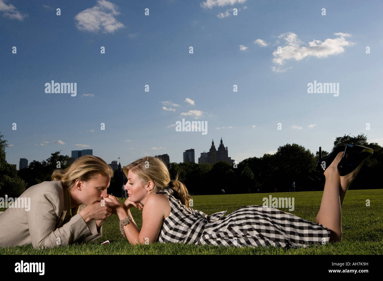 Young couple lying in a park and being romantic, Central Park, Manhattan, New York City, New York, USA Stock Photo