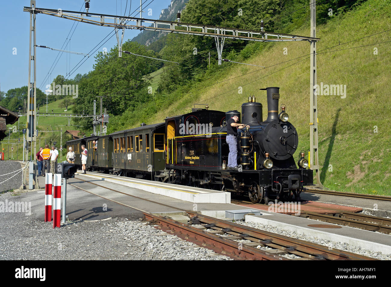 Special steam train on the Brunig line pausing at a station on Lake Brienz in Switzerland Stock Photo