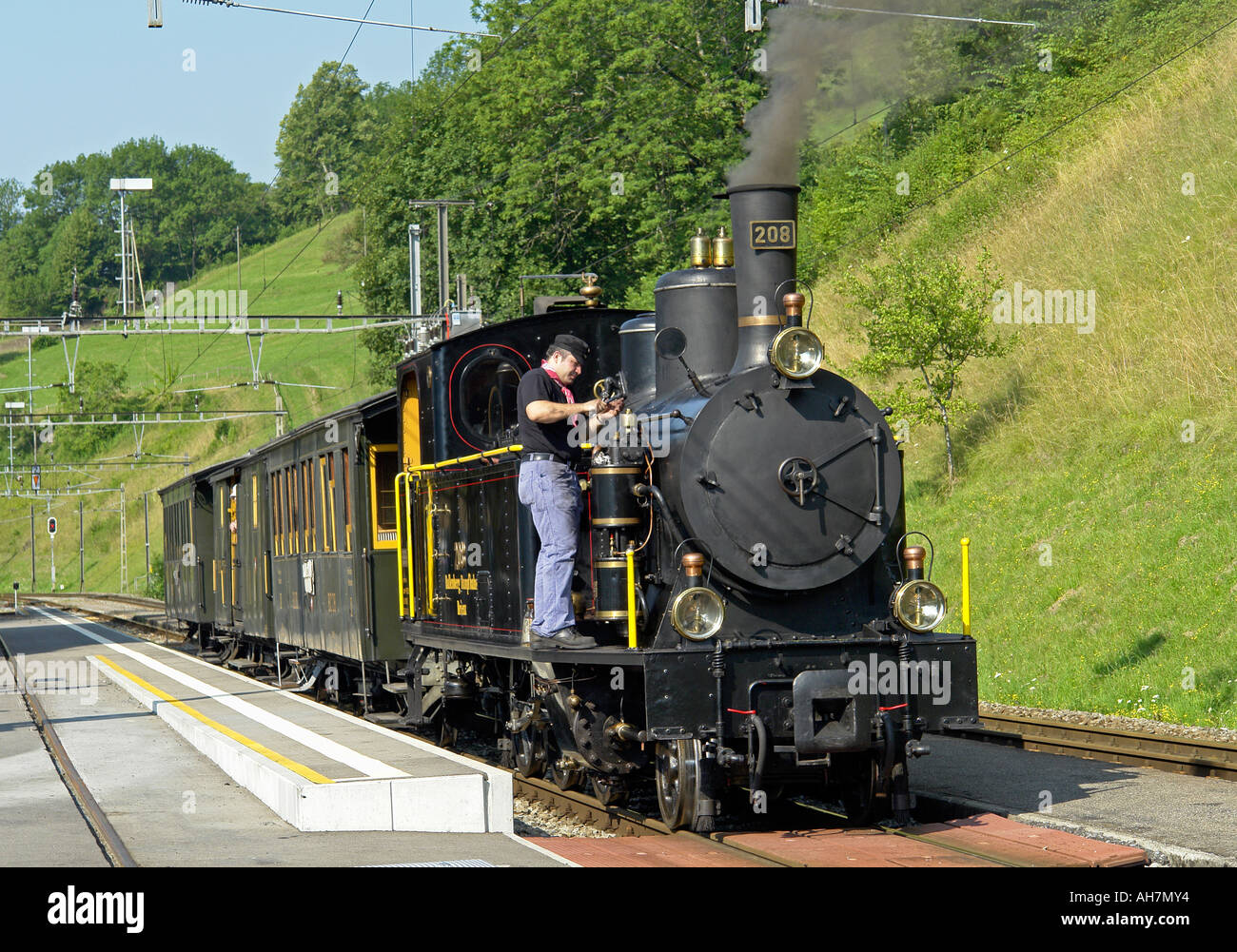 Special steam train on the Brunig line pausing at a station on Lake Brienz in Switzerland Stock Photo