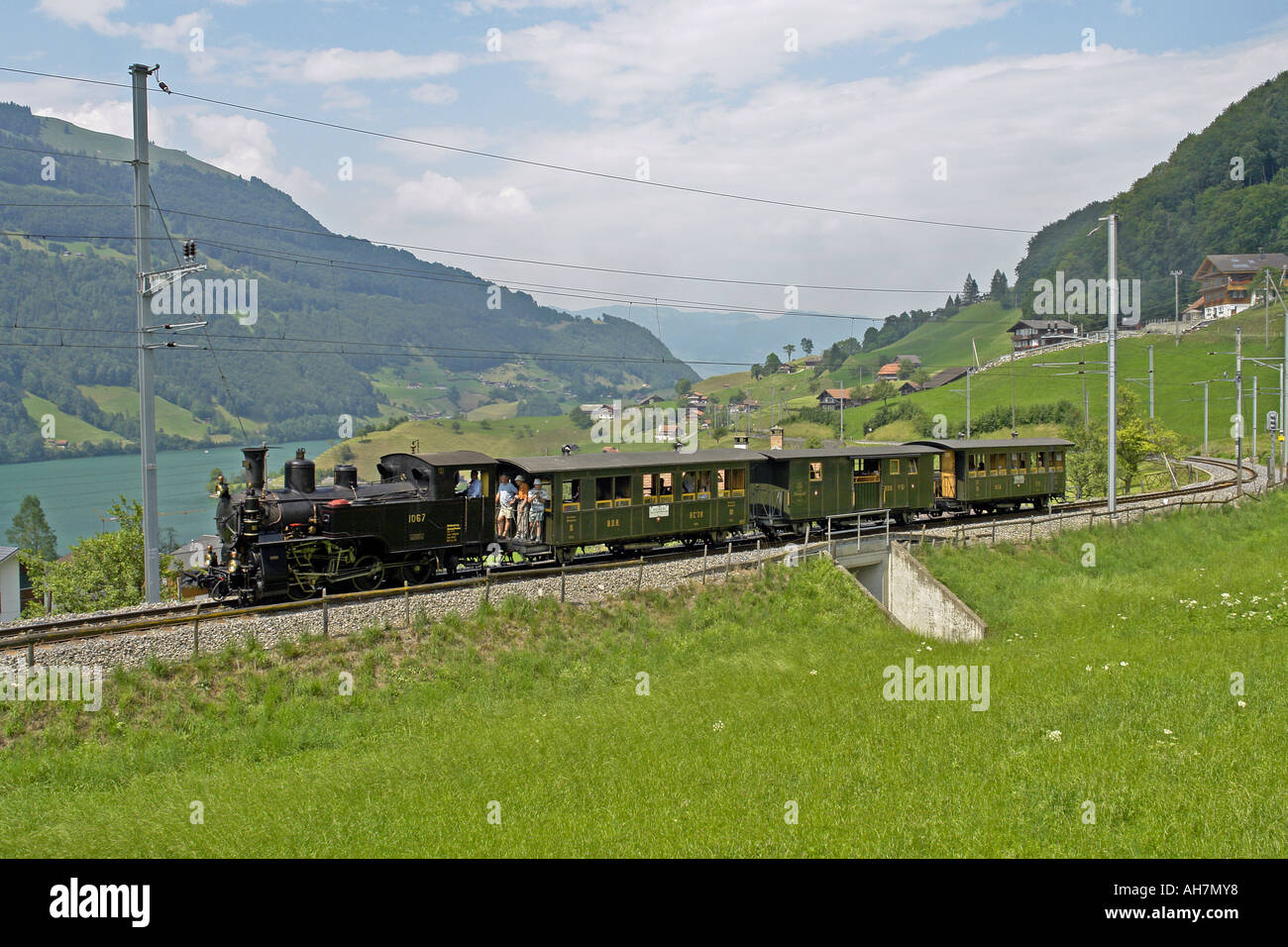 A special steam train is seen heading towards Kaisenstuhl from Giswill on the Brunig Line in Switzerland Stock Photo