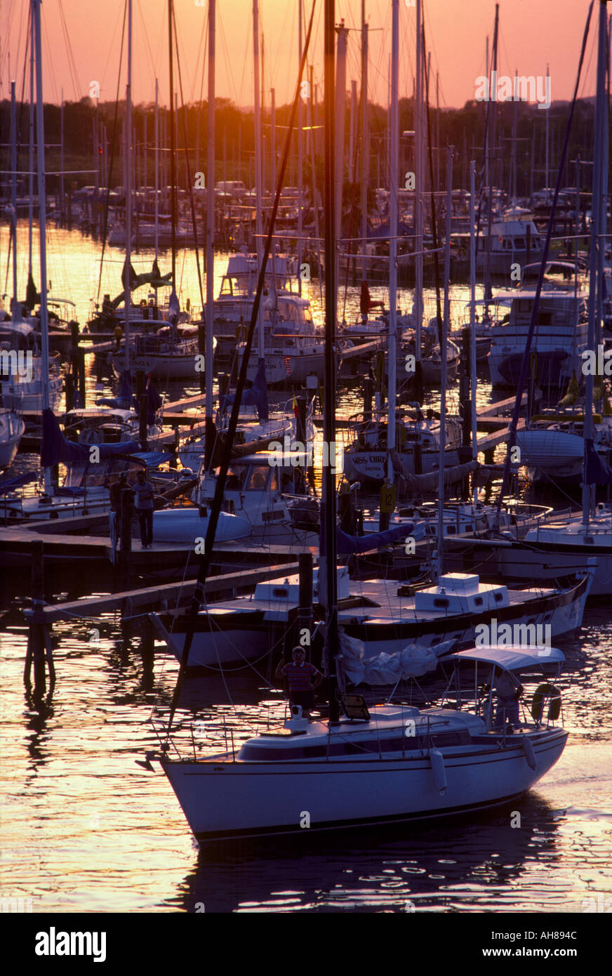 Sailboats in water and at docks in Kemah Texas at sunset Stock Photo