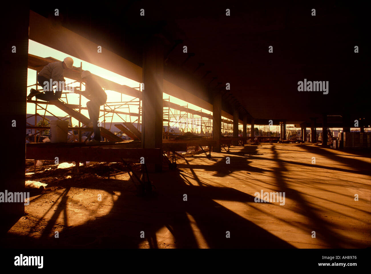 Construction workers building office building interior Stock Photo - Alamy