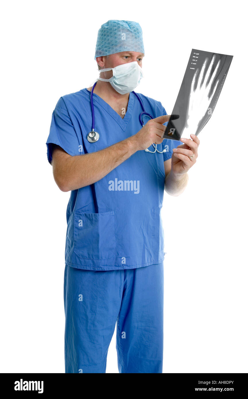 Surgeon in scrubs looking at an x ray Stock Photo