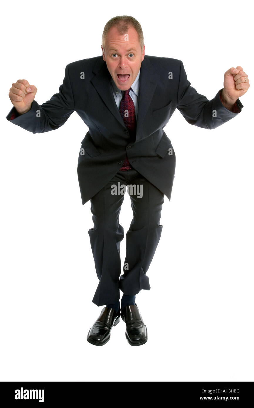 Businessman jumping in the air tiny bit of motion blur on trouser and jacket bottoms Stock Photo