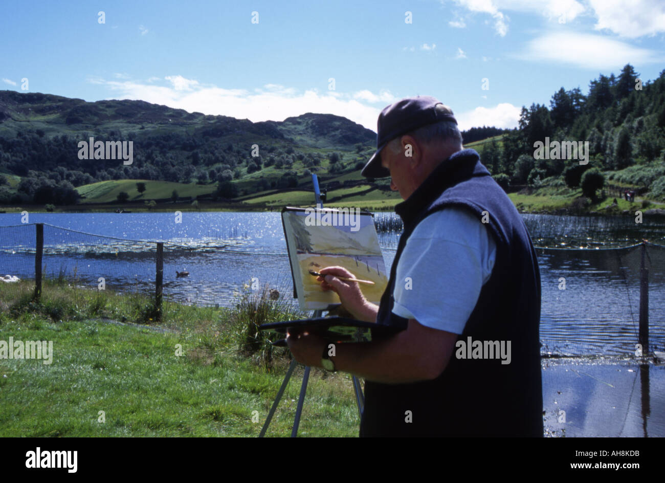 Man painting at Watendlath Lake, Lake District, Cumbria Stock Photo