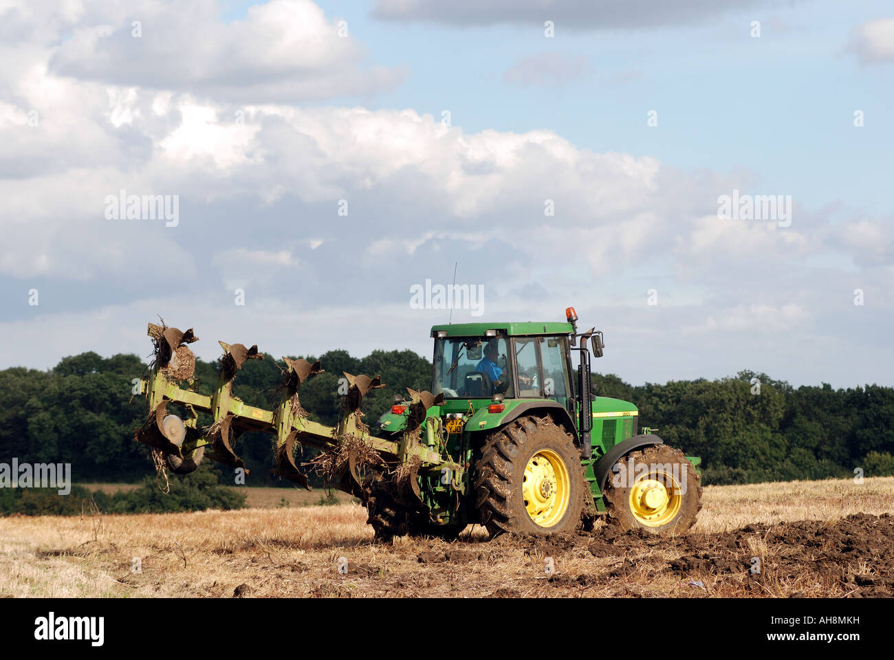 John Deere tractor turning during ploughing stubble field, Warwickshire