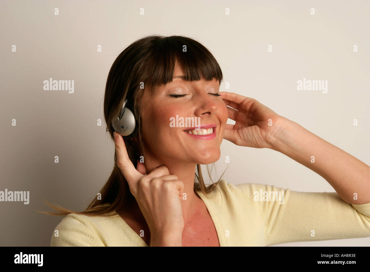 Young woman listening to music on headphones Stock Photo