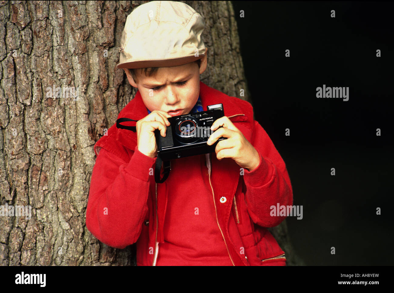 A young boy photographer taking pictures in the countryside full model release Stock Photo