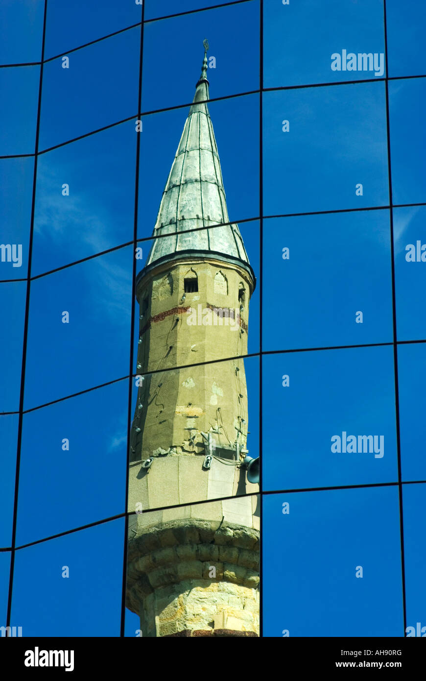 Reflection of old mosque in modern glass building, Prishtina, Kosovo, Eastern Europe Stock Photo