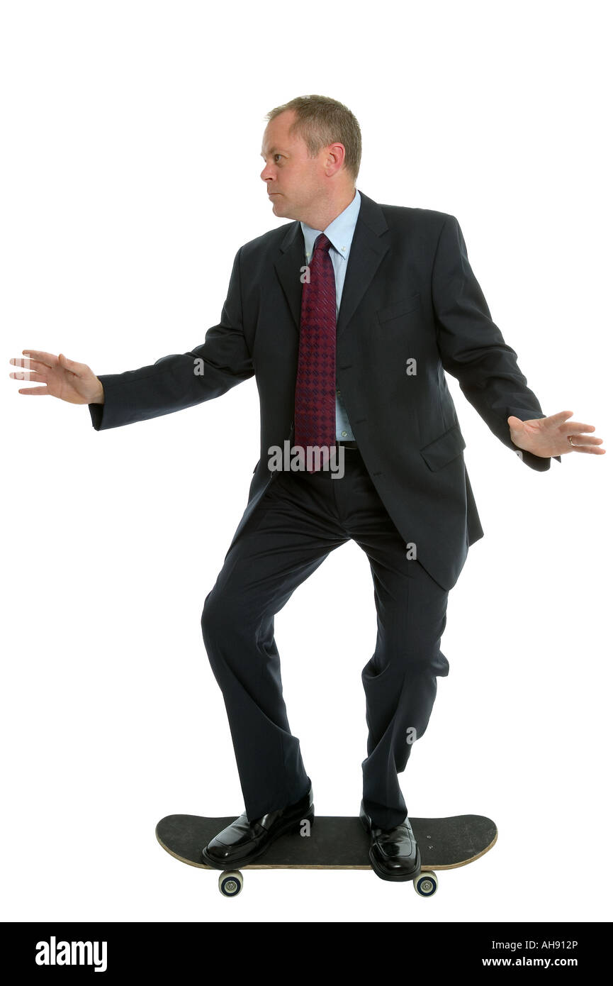 Businessman riding a skateboard to work Stock Photo