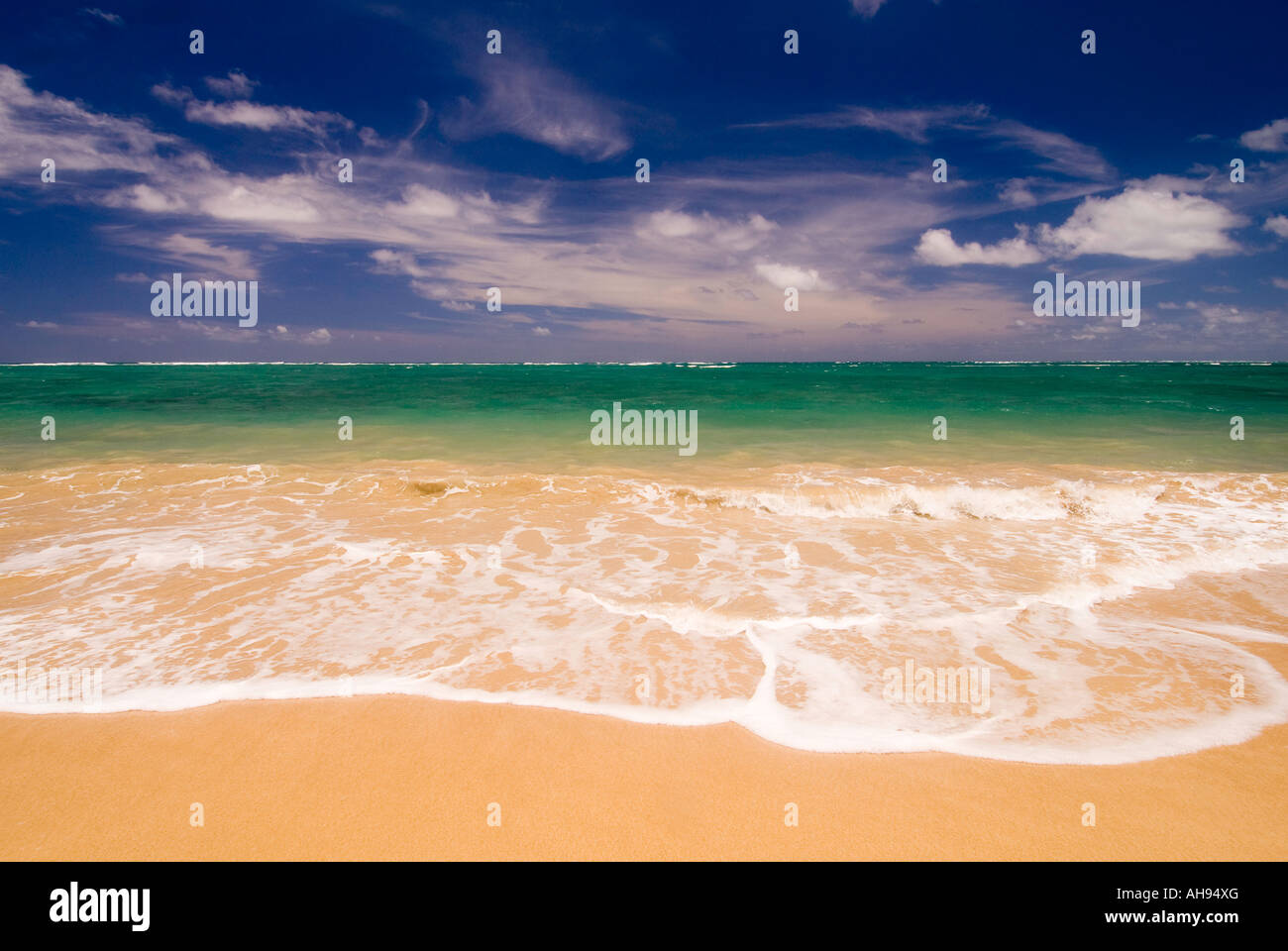 Hawaii Oahu Aqua blue and emerald green ocean waves roll onto a sandy beach North shore Stock Photo
