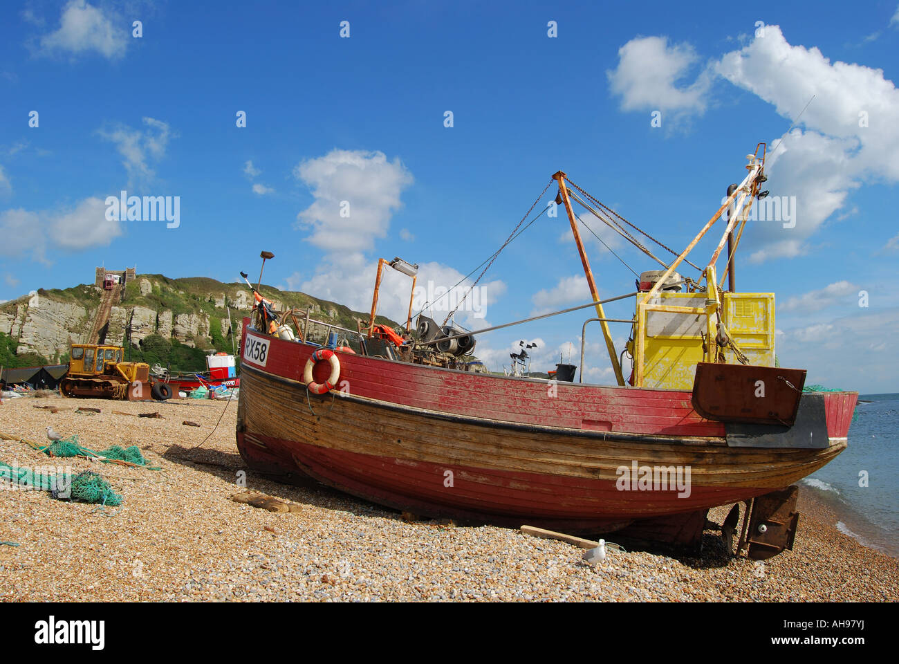 Fishing boat and nets on beach, The Stade, Hastings Old Town, Hastings, East Sussex, England, United Kingdom Stock Photo