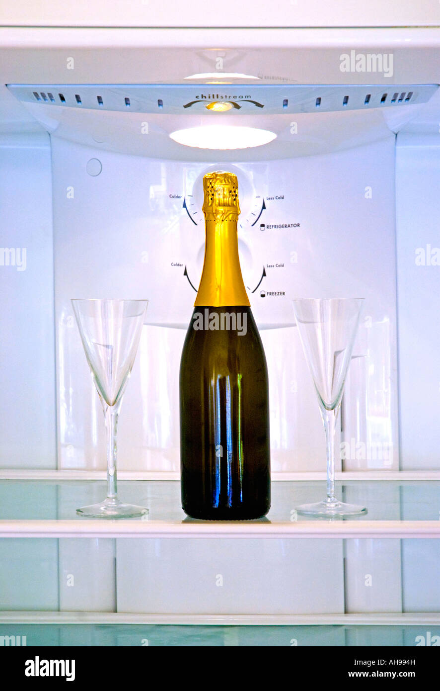 Bottle of champagne and two glasses in a refrigerator Stock Photo Alamy