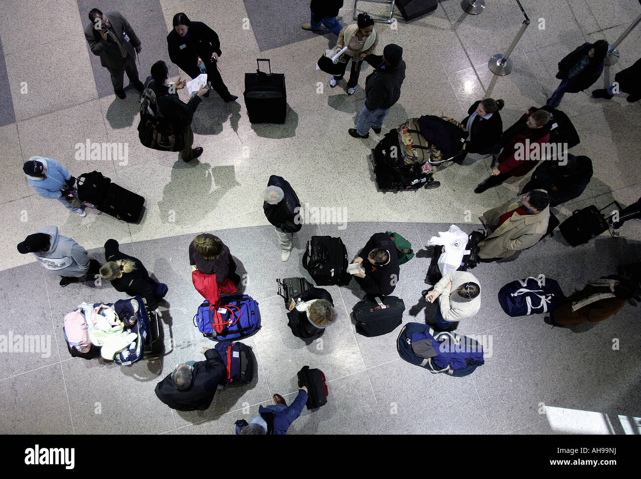 A group of  passengers wait in line to check-in inside a terminal at Logan International Airport in Boston Massachusetts Stock Photo