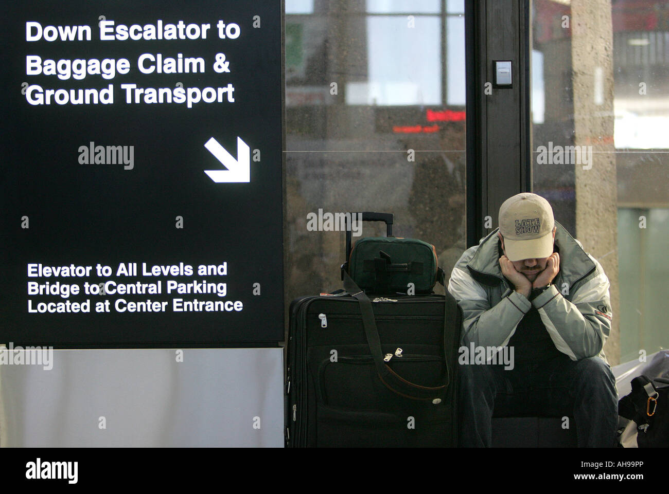 Air passenger waits out winter storm delay at Logan International Airport in Boston Massachusetts Stock Photo