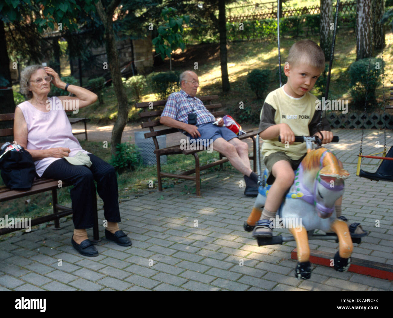 Having a ride on the merry go round Stock Photo - Alamy