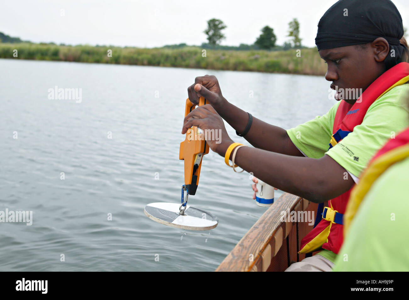 PRESERVES Libertyville Illinois African American male student use disc to test water clarity conduct water quality tests Stock Photo