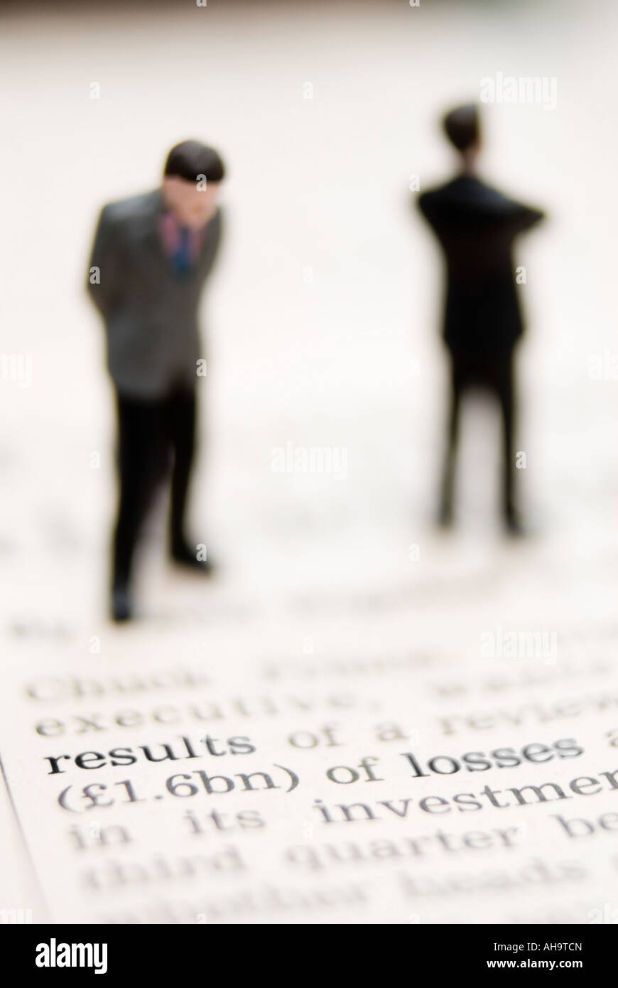 Businessmen standing on financial newspaper - bad news Stock Photo