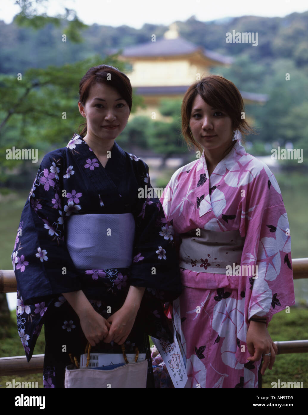 Japanese women in kimono stand in front of Kinkakuji temple Kyoto Japan Stock Photo