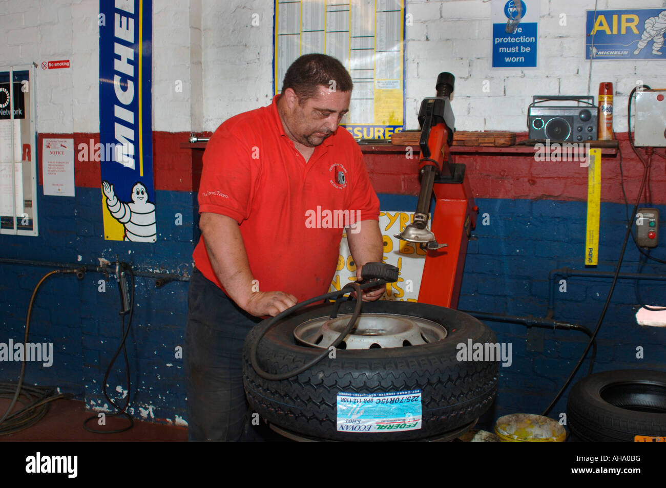 A Man Fitting A New Tyre Stock Photo