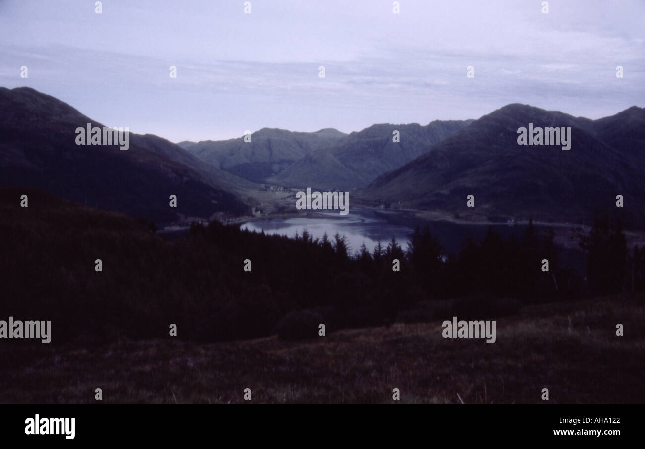 colour image looking down from the hillsides in the wilderness at a body off water which is surrounded by hillside and mountains Stock Photo