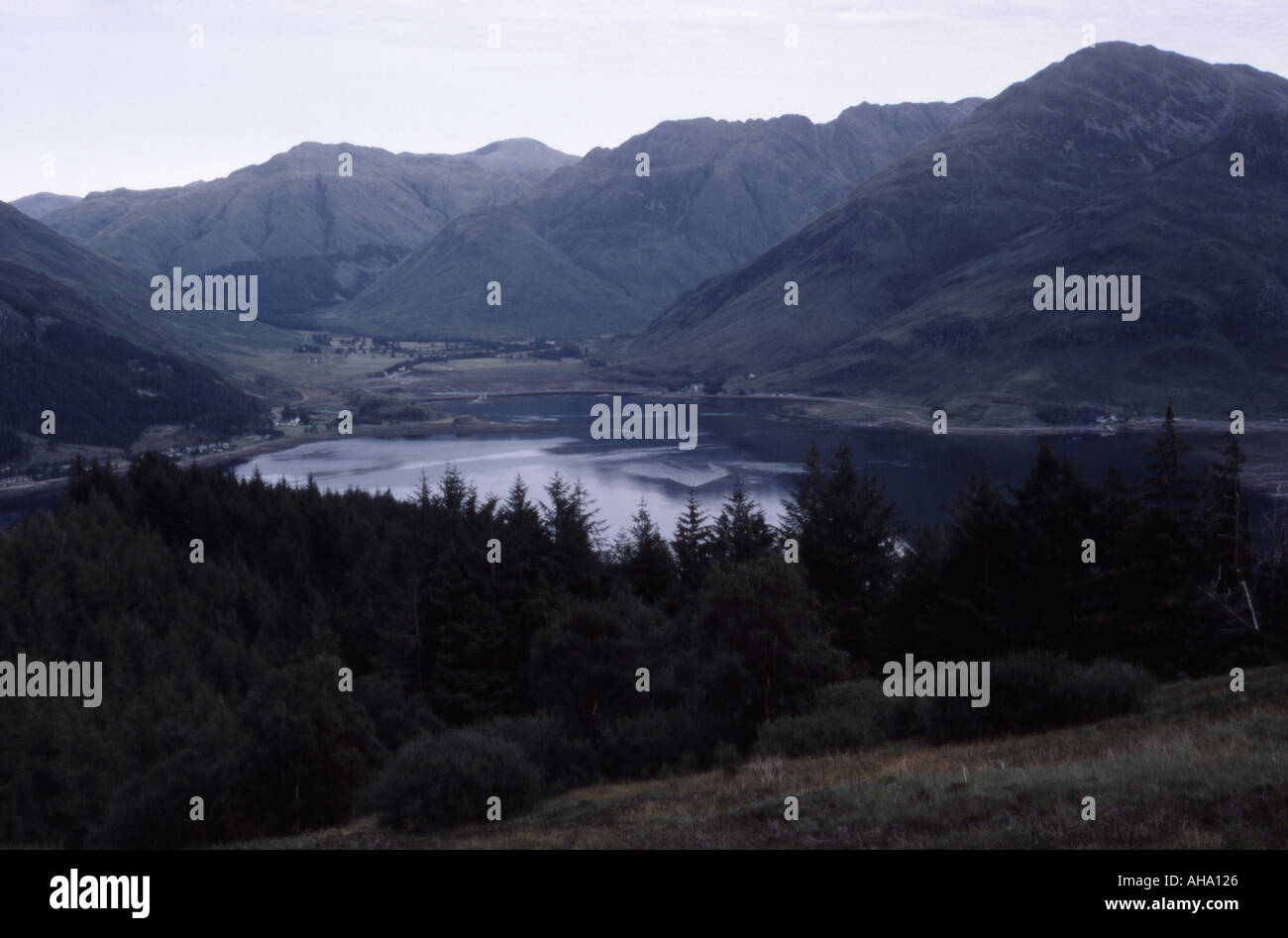 colour image looking down from the hillsides in the wilderness at a body off water which is surrounded by hillside and mountains Stock Photo