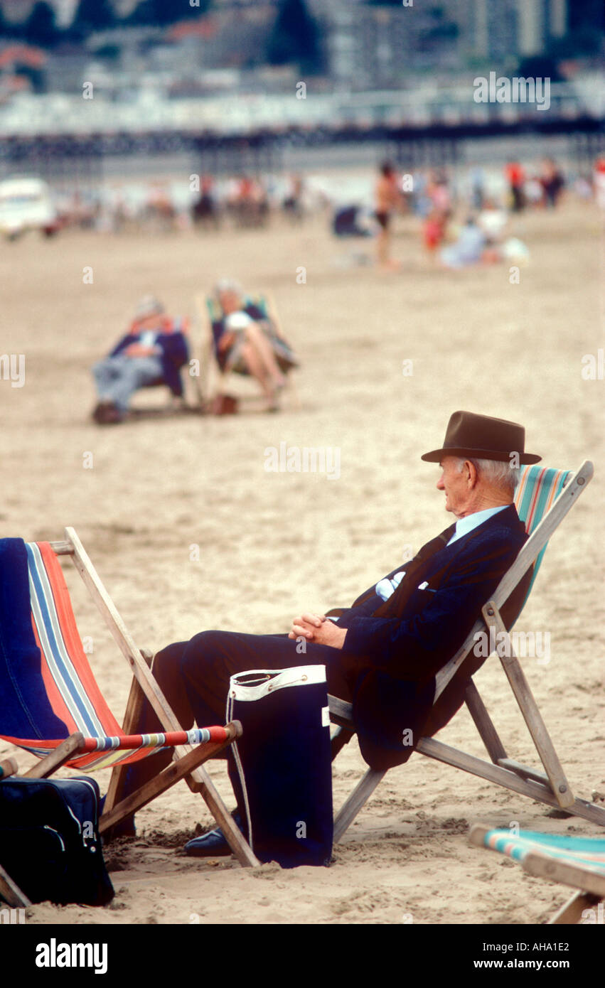 Old man in deckchair on Weston Super Mare beach Somerset England Stock Photo