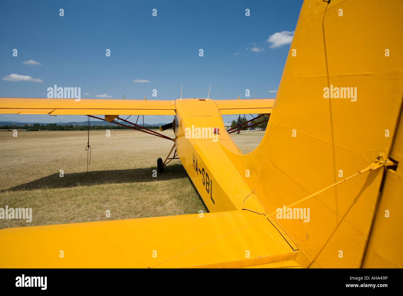 yellow old airplane on the ground backview wide perspective Stock Photo ...