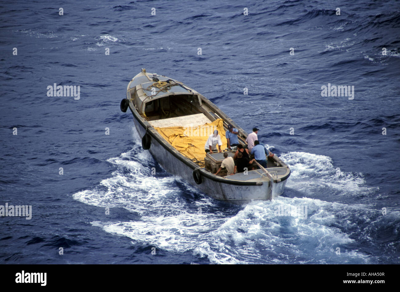 Pitcairn islanders in longboat en route from cruise ship to Adamstown settlement and Bounty Bay South Pacific UK territory Stock Photo