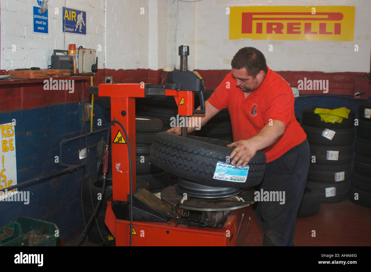 Man Fitting A New Tyre Stock Photo