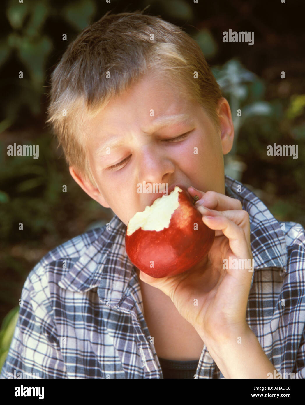 Boy eating an apple Stock Photo