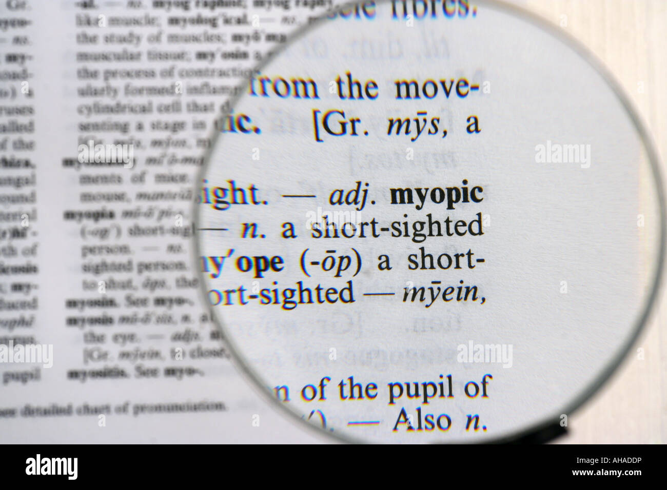 Dictionary definition of myopic viewed through magnifying glass Stock