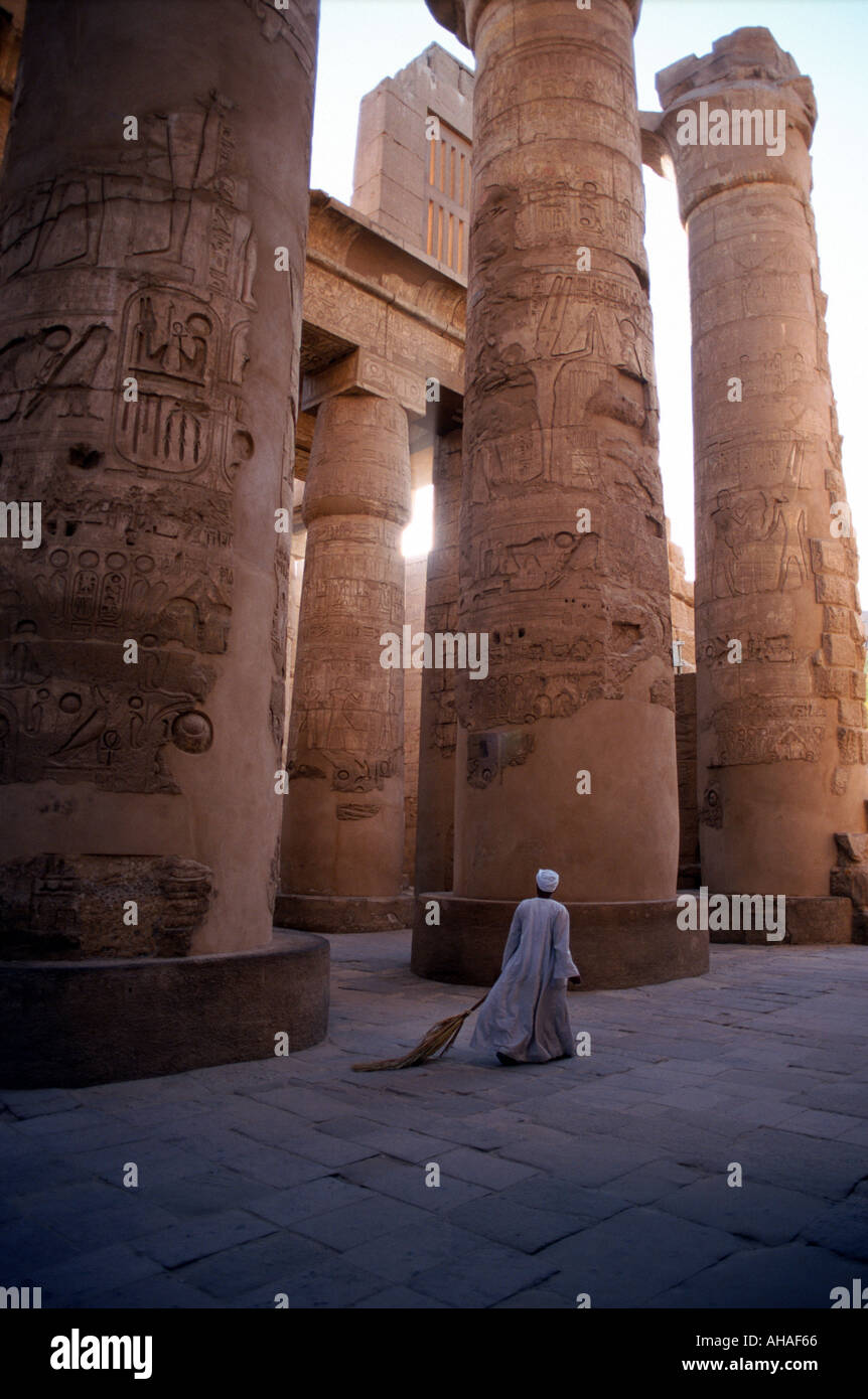 Early morning hours Temple of Karnak Luxor Egypt a man with a broom finishing cleaning the site before the tourists arrive Stock Photo