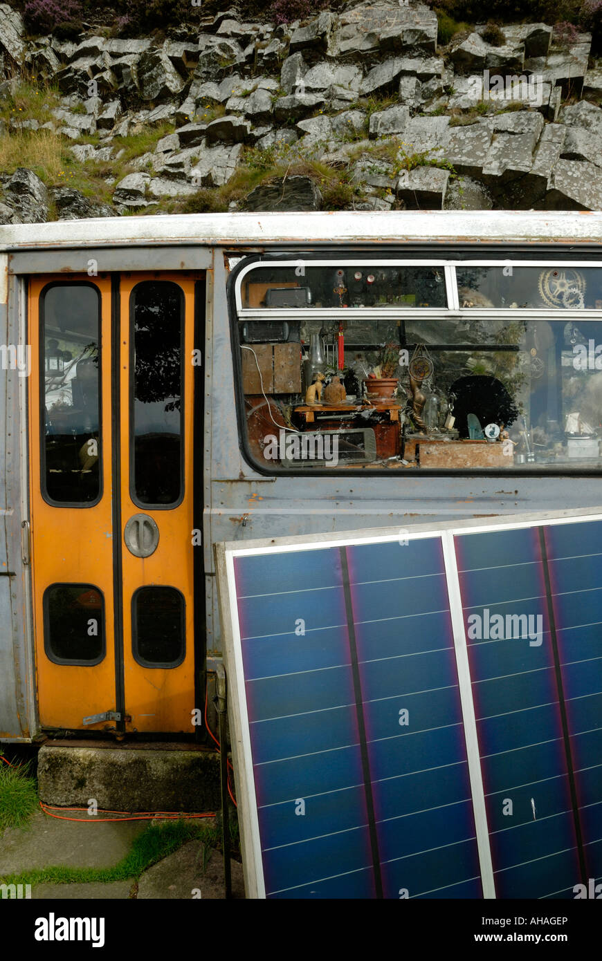 Old bus used as alternative style accomodation with solar panel  electrical power supply, Wales. Stock Photo