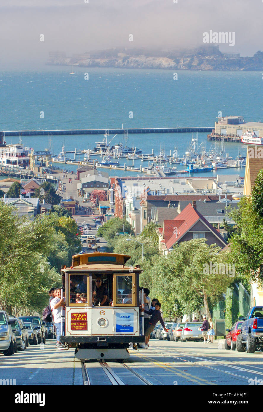 A San Francisco cable car climbs the hill with Alcatraz in the background Stock Photo