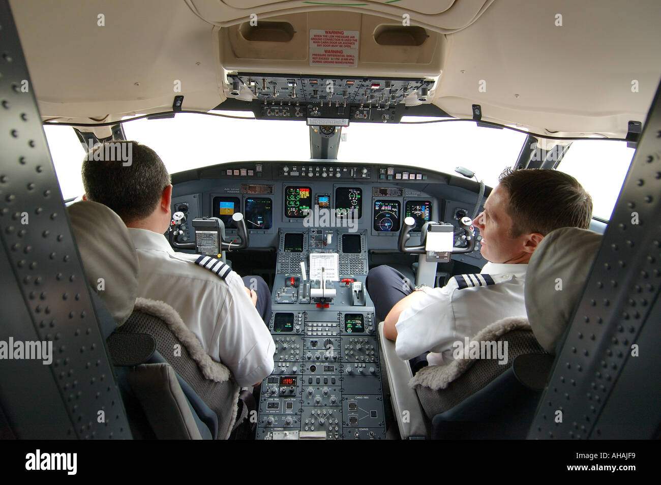 Inside the cockpit of a jet airliner with pilot and copilot Stock Photo