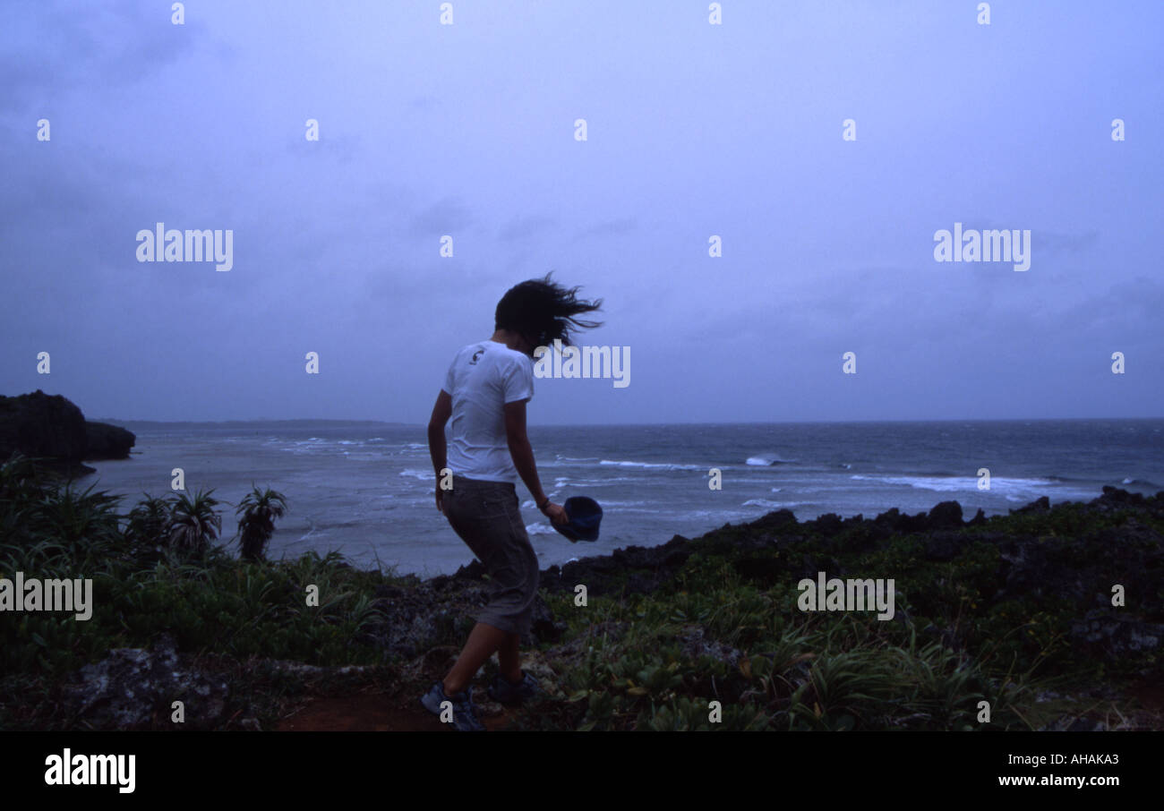 Japanese girl is blown by strong winds as a typhoon approaches Okinawa