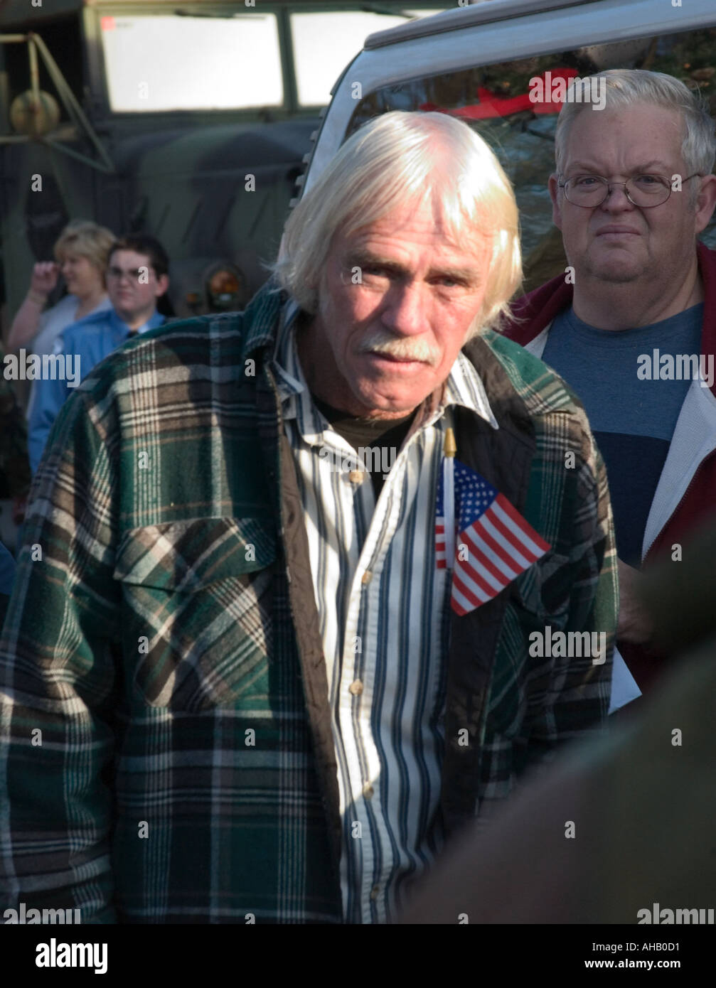 Caucasian Man 60-65 Yrs.With White Hair and US flag in Pocket Watches Ceremony of National Guard Unit Deployment to Iraq USA Stock Photo