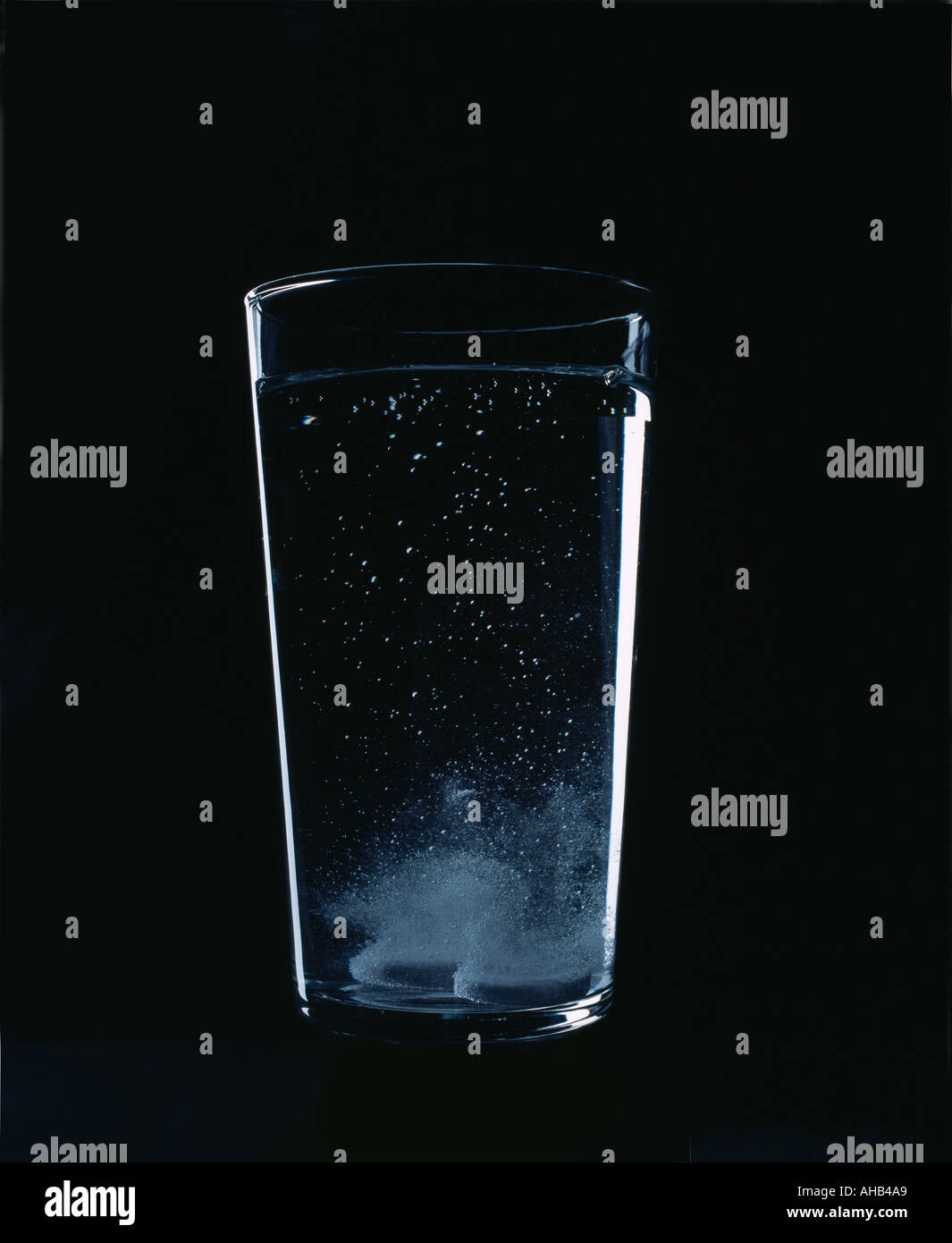 glass of water with bubbling tablets Stock Photo