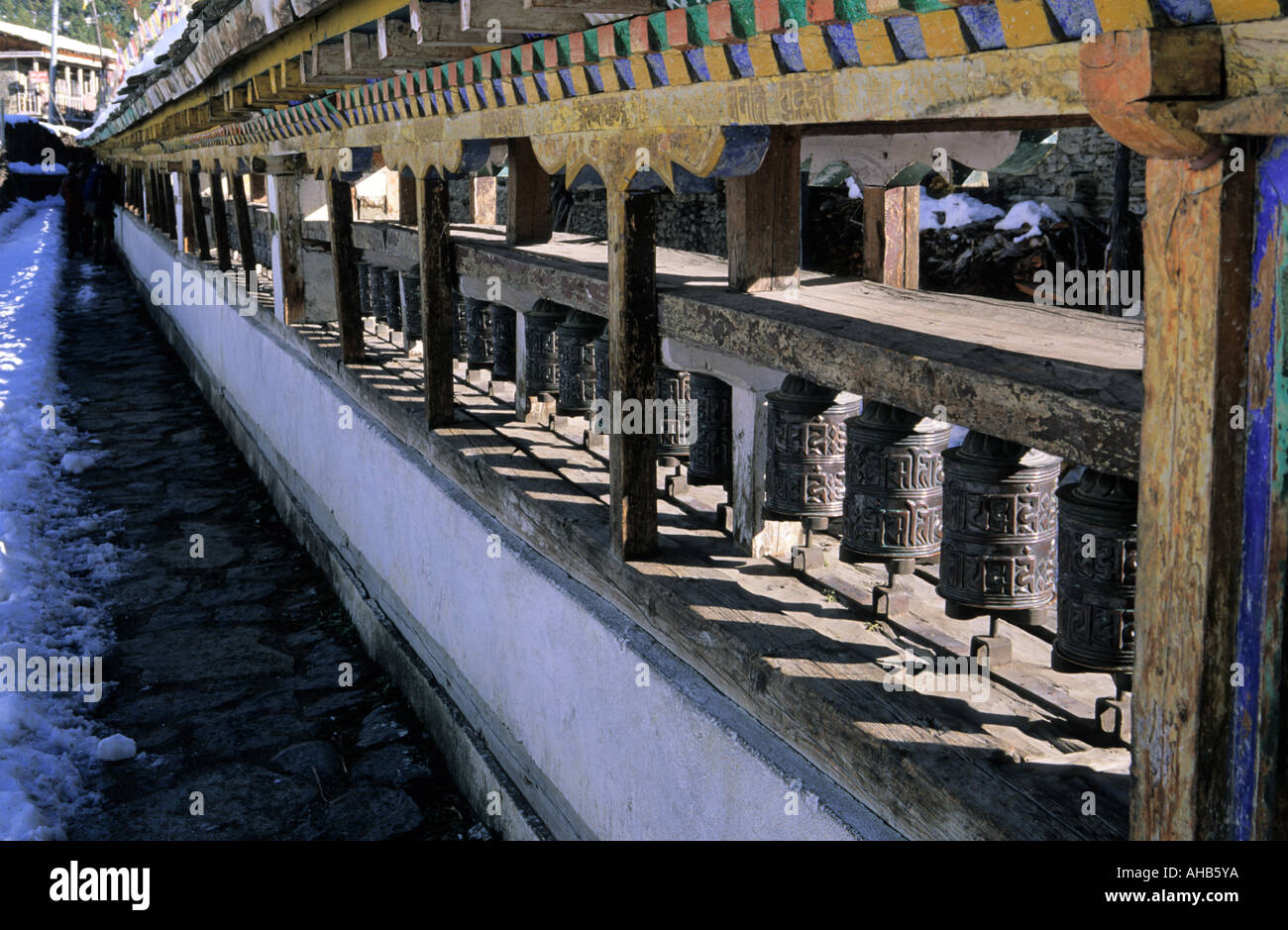 Traditional buddhist prayer wheels in Lower Pisang village Annapurna Conservation area Nepal Stock Photo