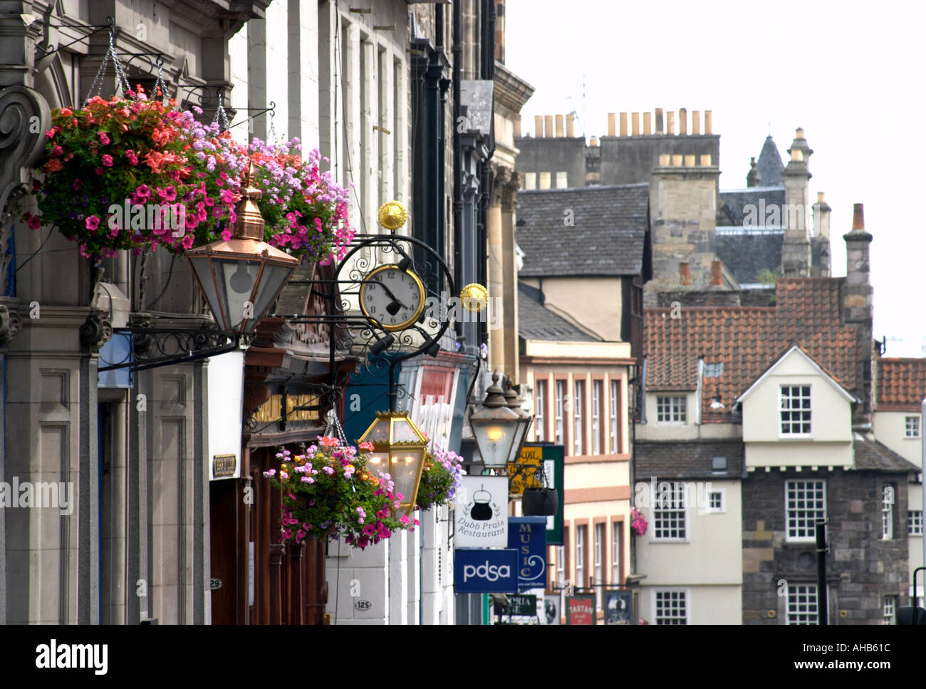 Flowers and shop signs looking towards John Knox house on the Royal Mile Edinburgh Stock Photo