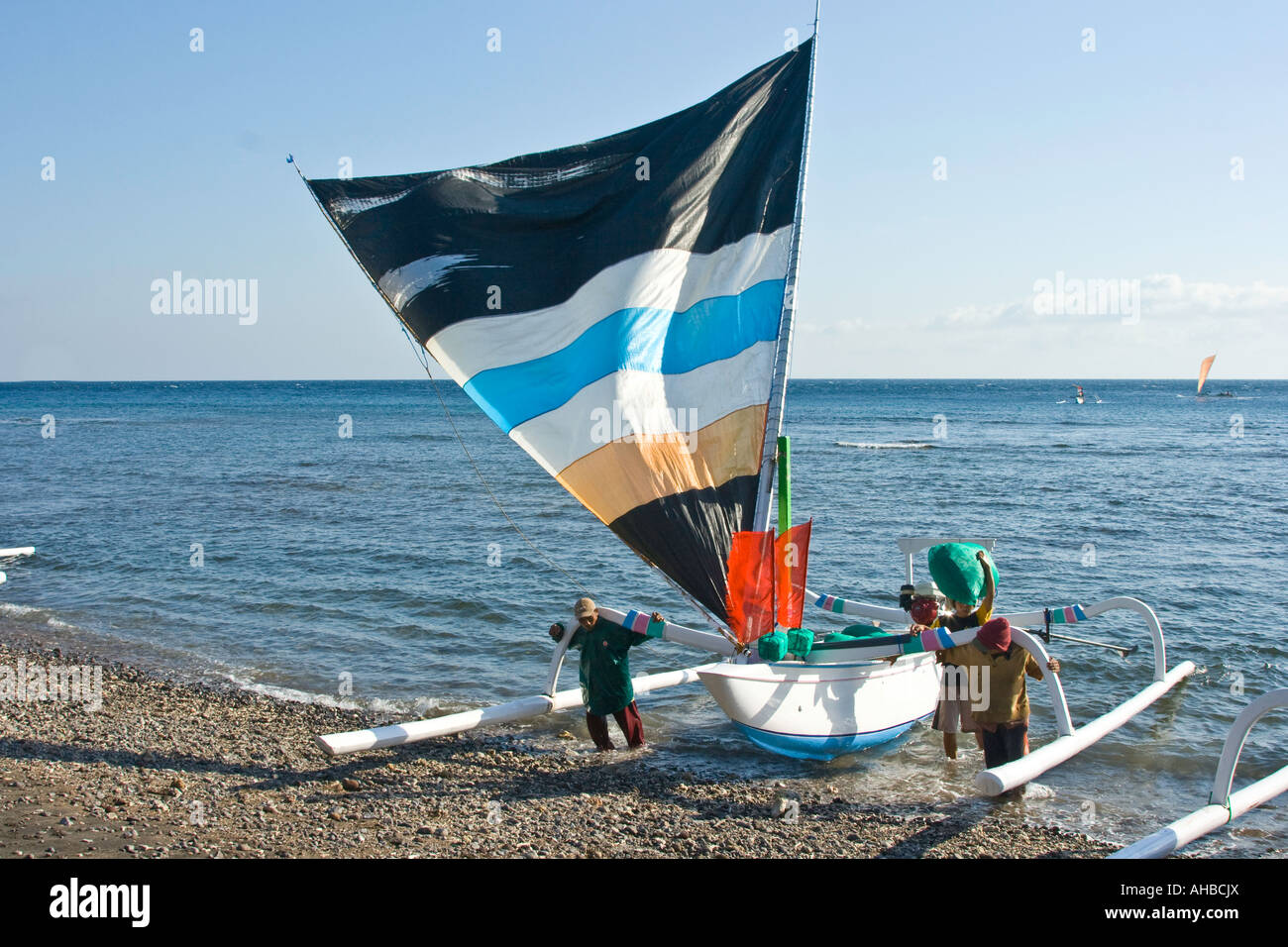 Jukung or Traditional Outrigger Fishing Sailboat Returning from Sea, Amed, Bali, Indonesia Stock Photo