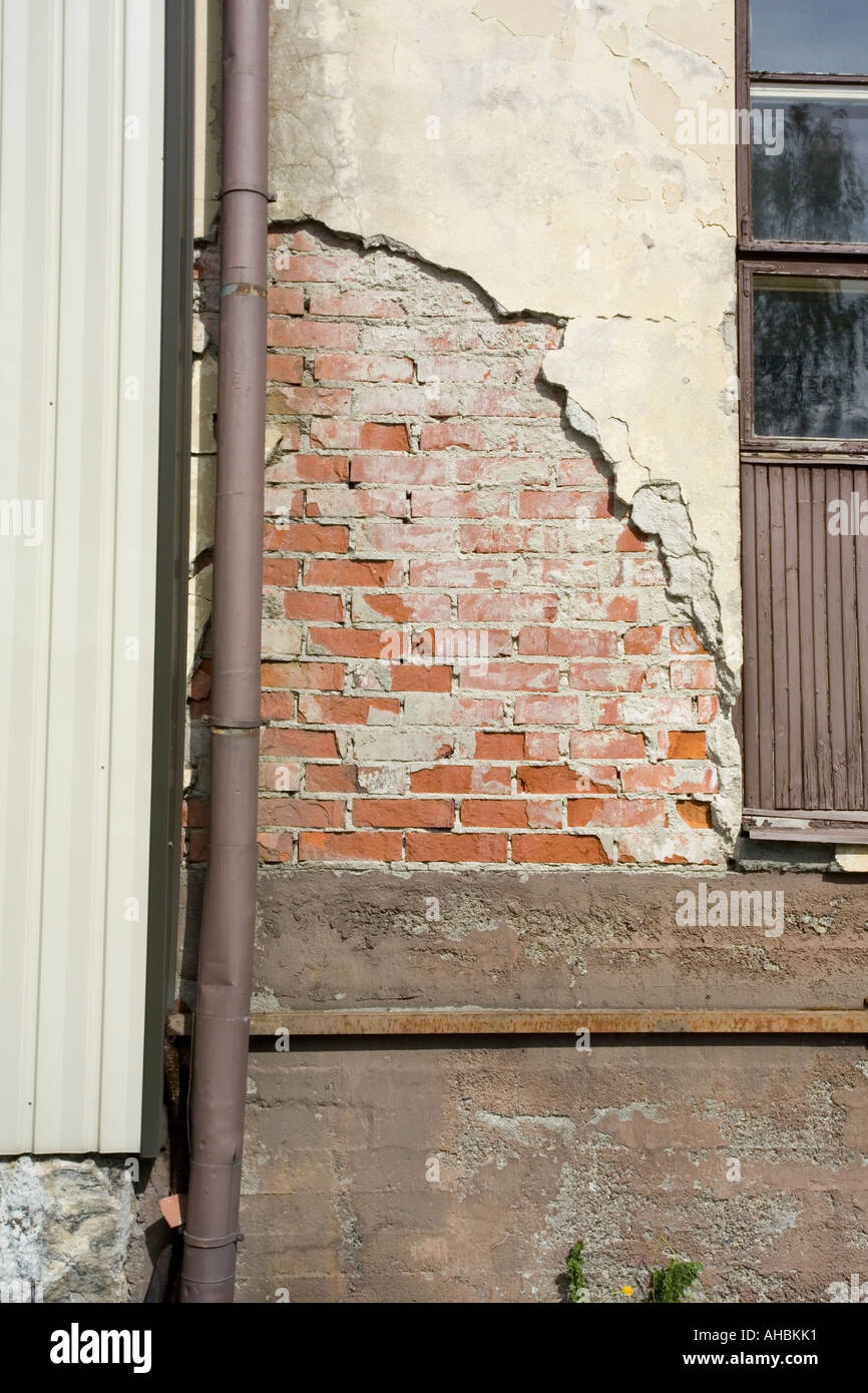 damaged plaster on building wall Stock Photo