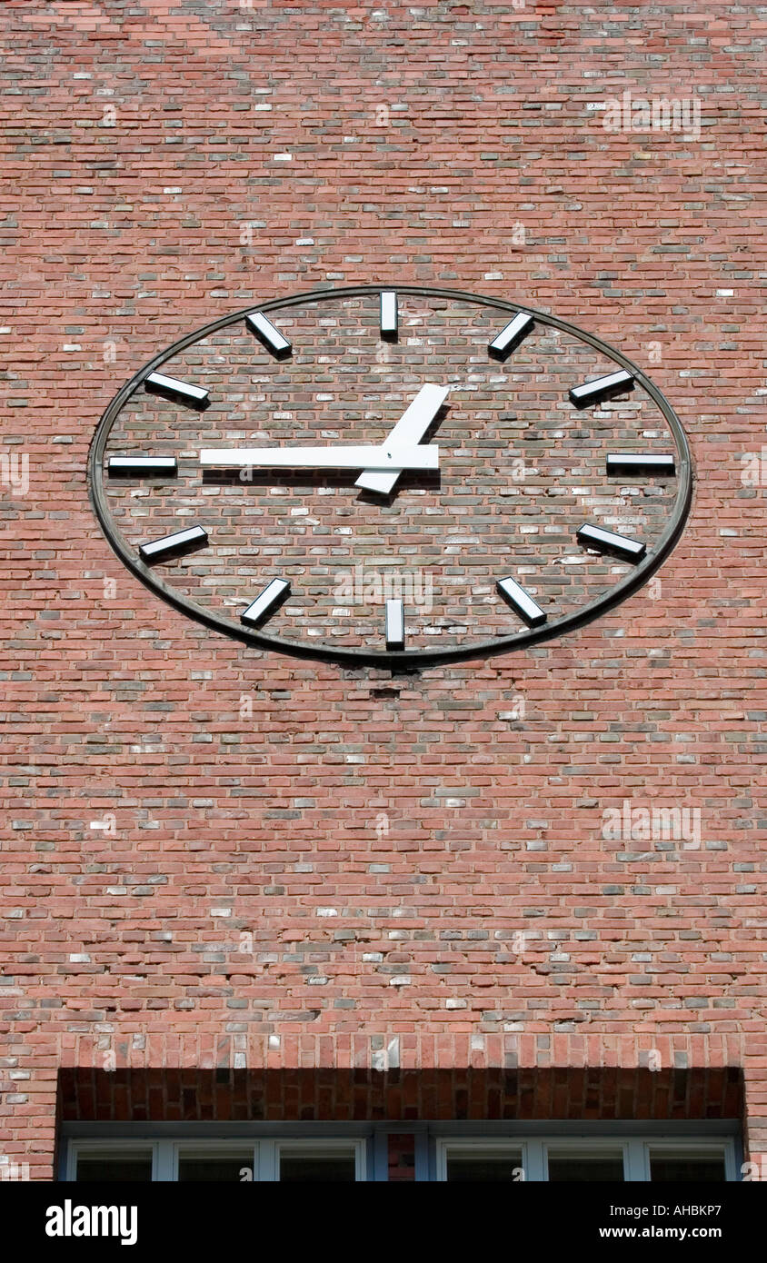 clock on red brick wall Stock Photo